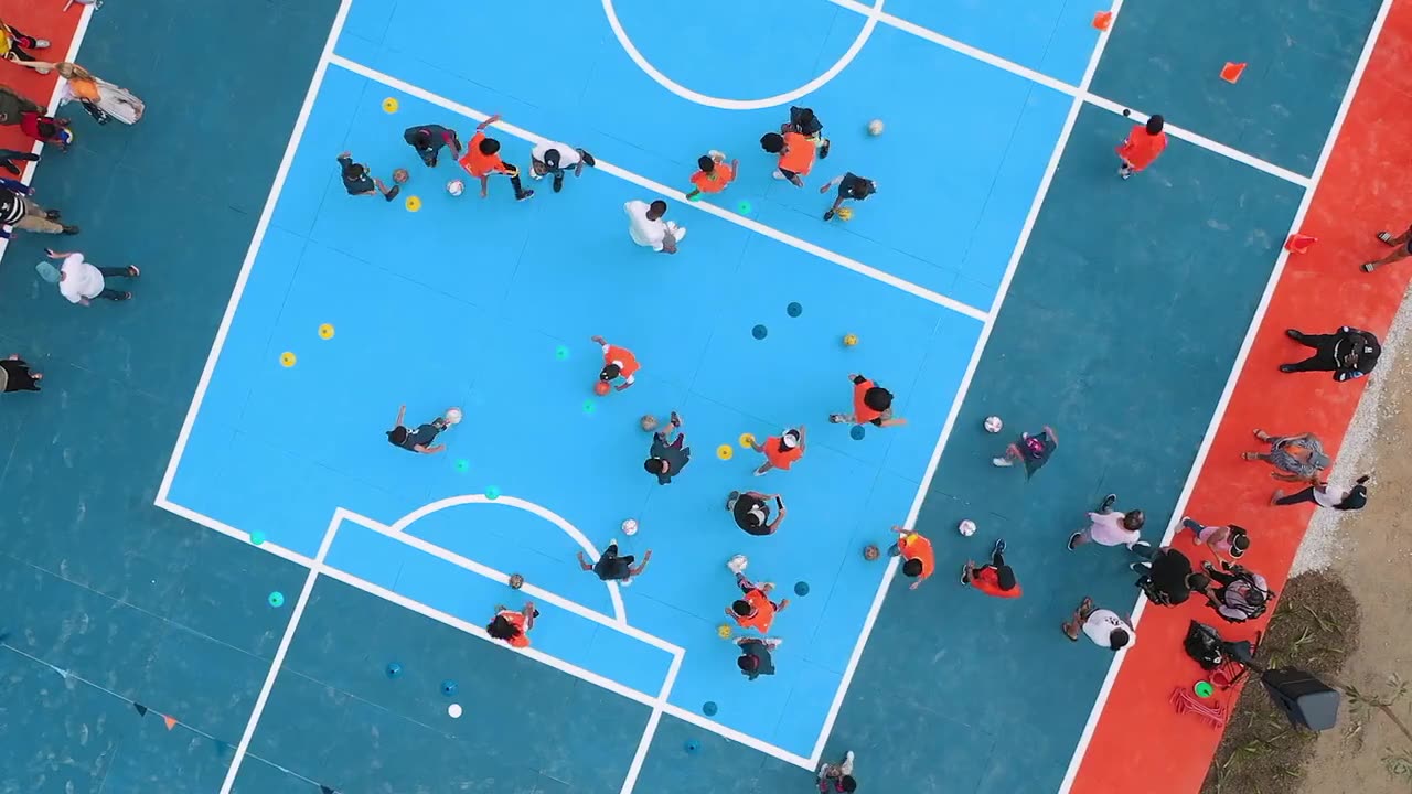 Blue and orange football pitch seen from the air