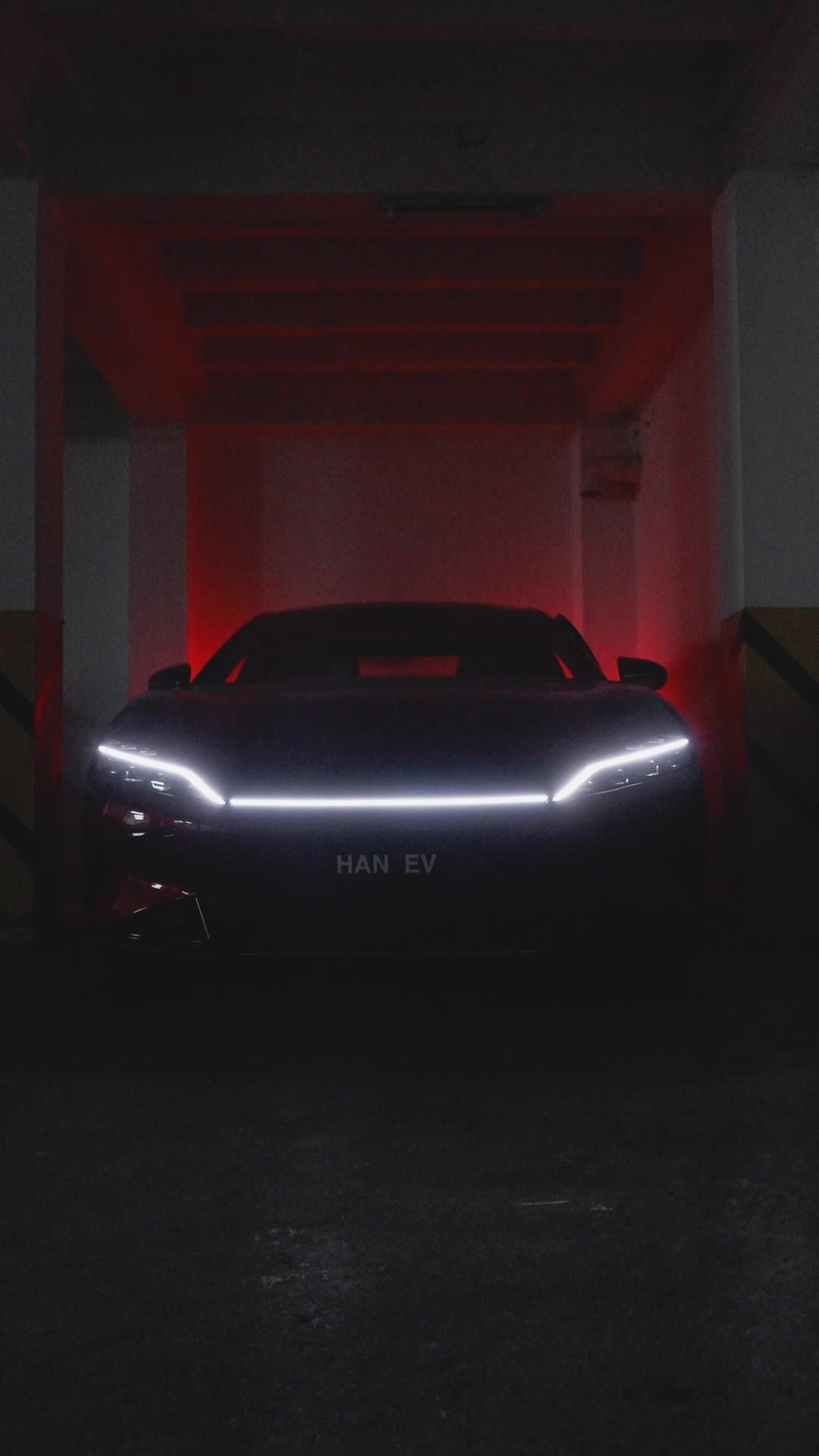 Front of the BYD HAN with its lights on in the dark