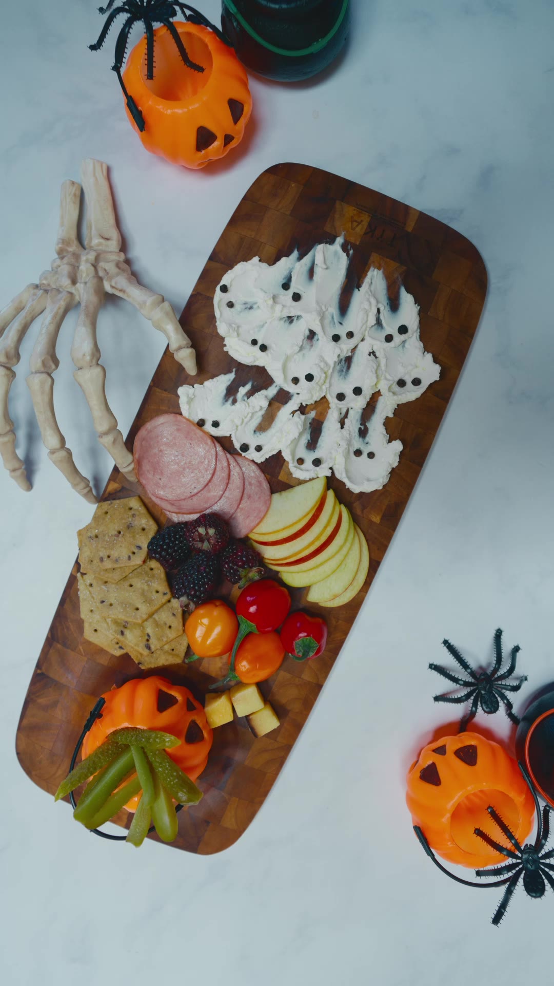 Finished Halloween charcuterie board with cream-cheese ghosts and pumpkins
